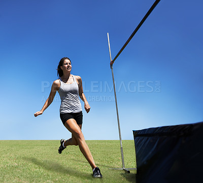Buy stock photo Woman, running and high jump athlete for sport training outdoor for competition, endurance or practice. Female person, leap and agility for cardio exercise or contest fitness, blue sky or flexible