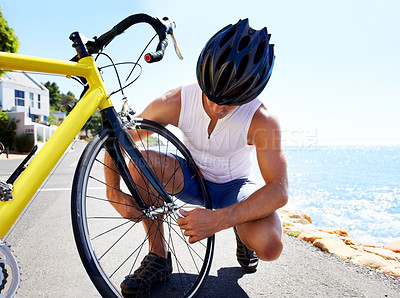 Buy stock photo Man, bicycle and tyre puncture or road change for safe transport, performance or repair. Male person, cyclist and ocean for gear improvement or endurance for triathlon training, sport or practice