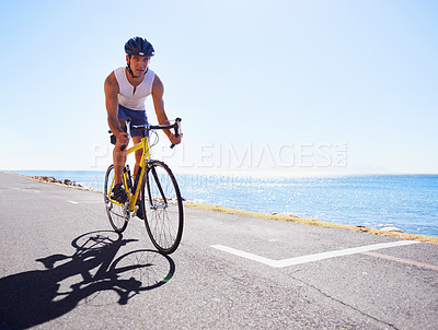 Buy stock photo Man, bicycle and sports fitness by ocean for performance endurance, competition or challenge. Male person, cyclist and practice workout for triathlon commitment for speed exercise, health or outdoor