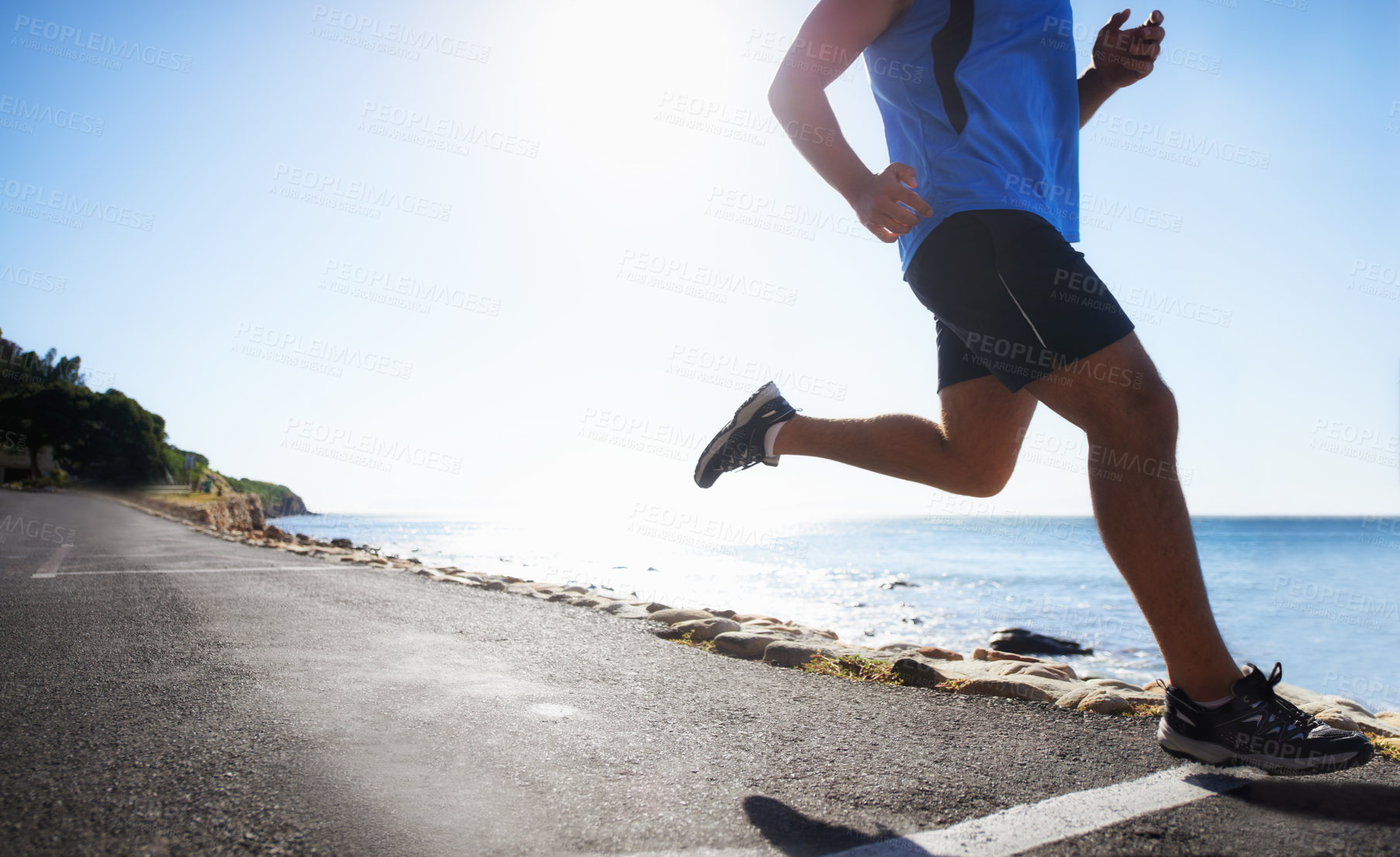 Buy stock photo Low angle view of a runner next to the ocean