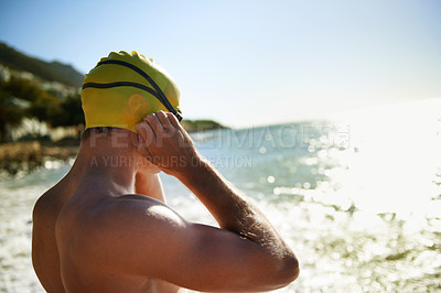 Buy stock photo Sea, beach and man for swimmer exercise, nature workout or outdoor practice in ocean, sea or water waves. Swimwear, swimming cap and athlete prepare to start challenge, fitness performance or cardio