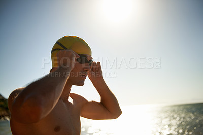 Buy stock photo Sports, beach and man for swimming exercise, nature workout or outdoor practice in ocean, sea or water waves. Mockup sky space, goggles and swimmer for challenge, fitness performance or summer cardio