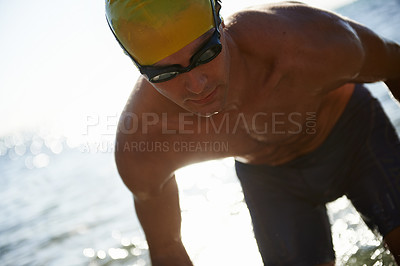 Buy stock photo Beach, sports and man for swimming training, workout or exercise in sea, nature and tropical island hobby. Active swimwear, travel and competitive male swimmer for cardio, fitness or morning practice