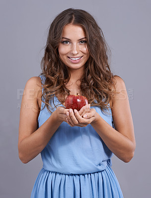 Buy stock photo Happy woman, portrait and apple for natural nutrition, diet or healthy snack on a gray studio background. Face of female person, brunette or model smile with red organic fruit for health and wellness
