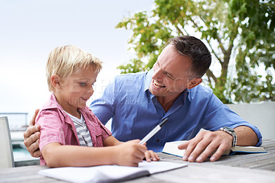 Buy stock photo Notebook, learning and happy man with son at table in backyard for child development, knowledge and studying. Education, books and help, father and kid on patio with homework, writing and drawing.