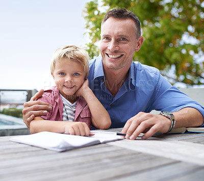 Buy stock photo Portrait, homework and dad with son at table in backyard for child development, knowledge and studying. Education, books and help, happy man and kid on patio with notebook, fun learning and drawing.