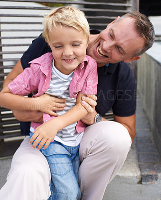 Buy stock photo Laughing, happy and dad tickling child for bonding together in backyard at family home. Smile, funny and father playing and having fun with boy kid by wood gate for quality time outdoor a house.