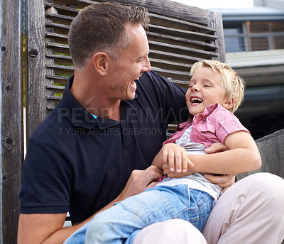 Buy stock photo Laughing, happy and father tickling child for bonding together in backyard at family home. Smile, funny and dad playing and having fun with boy kid by wood gate for quality time outdoor a house.