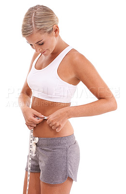 Buy stock photo Fitness, health and woman with tape measure for abdomen in studio isolated on a white background. Diet, wellness and slim female model measuring waist to track weightloss goals, progress or targets.