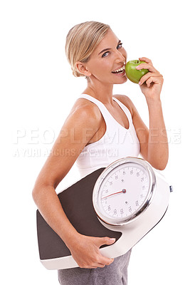 Buy stock photo Woman, eating and apple with scale for diet, weight loss or healthy nutrition against a white background. Portrait of happy isolated female with smile for organic, vitamin or dieting food for measure