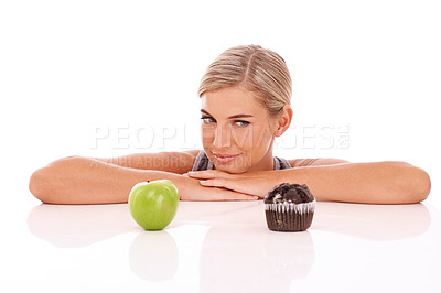 Buy stock photo Woman, diet and choose with apple, muffin and undecisive girl isolated on white studio background. Female, lady and decide between fruit, chocolate dessert and snack for lunch, thinking and choice