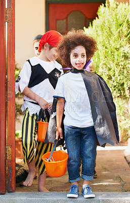 Buy stock photo Children, halloween and trick or treat outdoor in costume for celebrate, holiday and spooky outfit or tradition. Kids, event and autumn role play with basket, fancy dress or happy in garden of home 