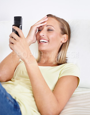 Buy stock photo Happy, laugh and woman with phone in a bed for funny social media, meme or gif communication. Smartphone, joke and female person in a bedroom streaming online comic, video or silly chat in a house
