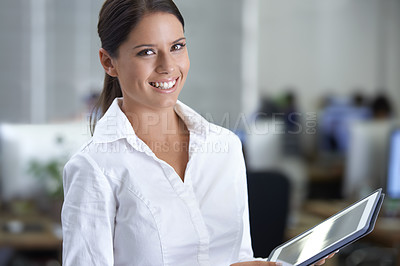 Buy stock photo A gorgeous young business woman using her digital tablet in the office
