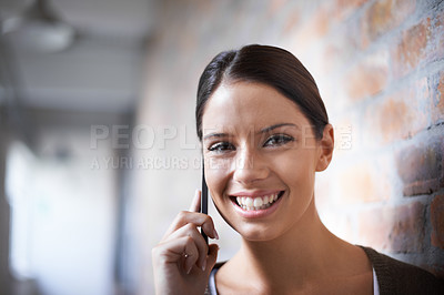 Buy stock photo Phone call, portrait or happy woman in workplace for communication, gossip or chat by office wall. Talking, smile or face of designer listening in conversation or speaking of news, feedback or ideas