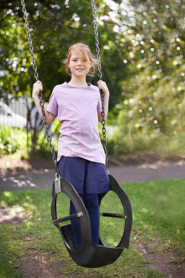 Buy stock photo Girl, child and tire swing in garden, portrait with smile and playing outdoor with childhood and nature. Kid in nature, playground and summer, playful and fun with game, happy in backyard in England