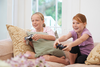 Buy stock photo Home, controller or children gaming to play online with joystick on couch or sofa in living room. Happy kids, fun experience or young female gamers with smile for video games, contest or technology