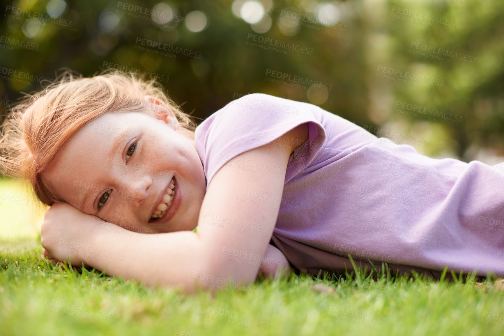 Buy stock photo Happy, portrait and young girl on grass, relax outdoor for fun and rest in garden or backyard. Youth, free time and playing in park, field or environment with smile on face for summer vacation