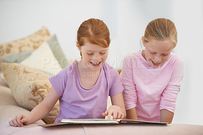 Buy stock photo Sisters, smile or happy kids reading book for learning, development or studying literacy together. Education, children or girl siblings in home for storytelling, hobby or knowledge of literature