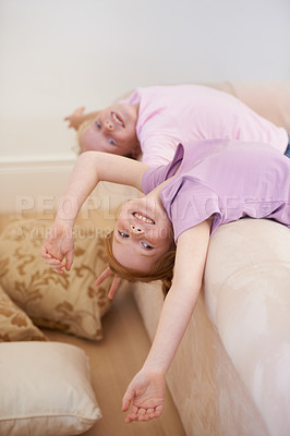 Buy stock photo Portrait of happy kids, sisters or upside down on couch for love, bond and care for trust or support. Friends, family home or girl siblings in lounge together to play games with freedom and smile
