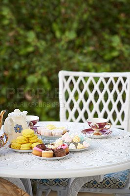Buy stock photo Table, tea party and cake in garden or cupcakes for birthday celebration, macarons or beverage. Backyard, chair and sweet dessert or food on patio or candy brunch for holiday relax, event or hungry