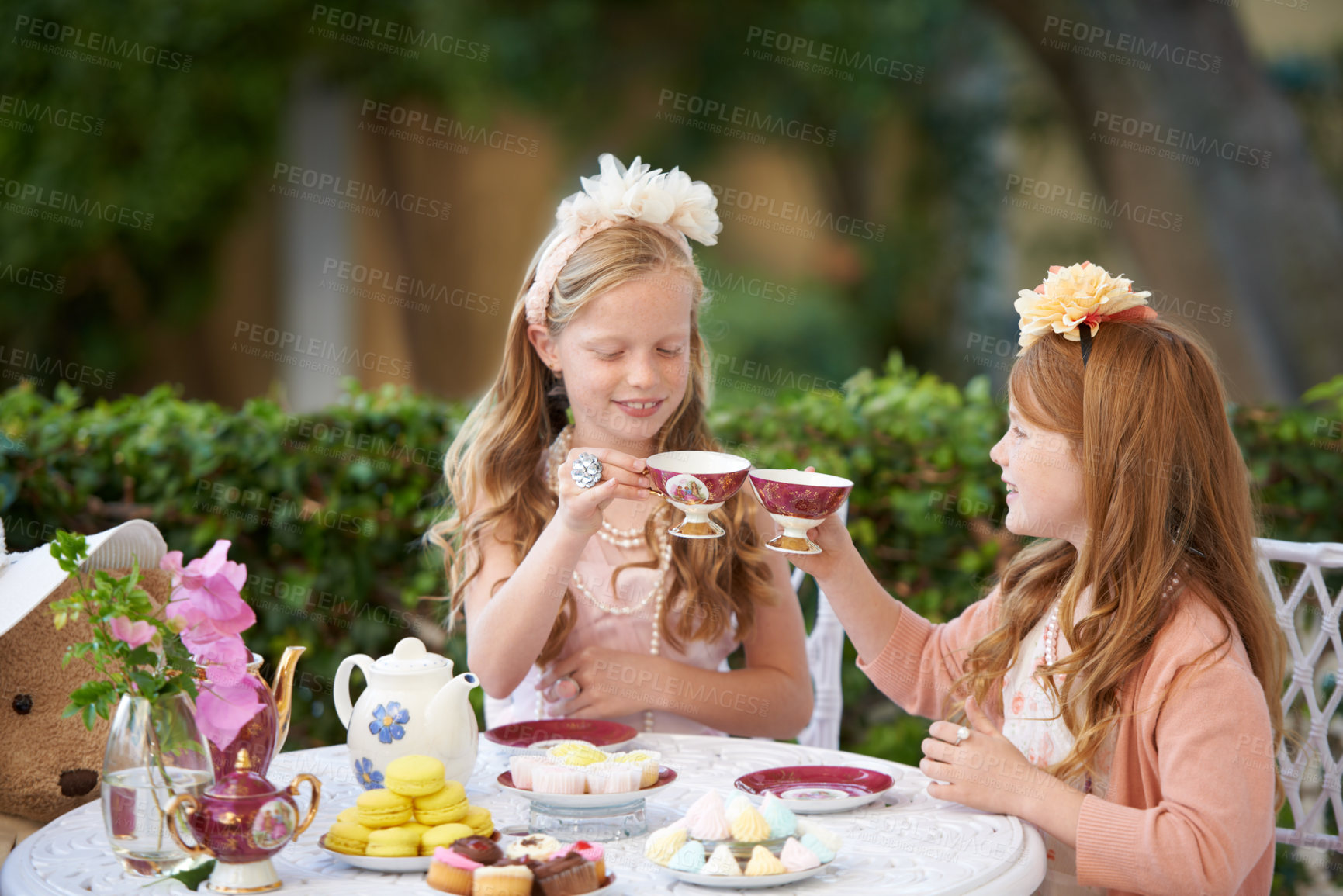 Buy stock photo Two young girls having a tea party in the backyard