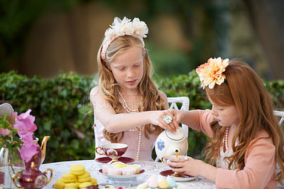 Buy stock photo Playing, tea party and girl children in garden for pretend with cake, flowers or kid fun. Princess, cookies and fantasy with friends, teapot and backyard with celebration, imagination and drink.