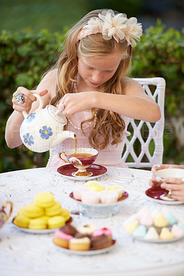 Buy stock photo Girl, child and pouring tea in garden with party for birthday, celebration and playing outdoor in home. Person, kid and porcelain cup in backyard of house with dress up, beverage and role play fun