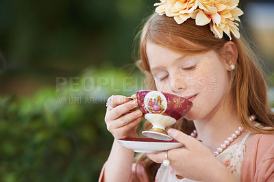 Buy stock photo Girl, child and drinking tea in garden with party for birthday, celebration and playing outdoor in home. Person, kid and porcelain cup in backyard of house with dress up, beverage and role play fun