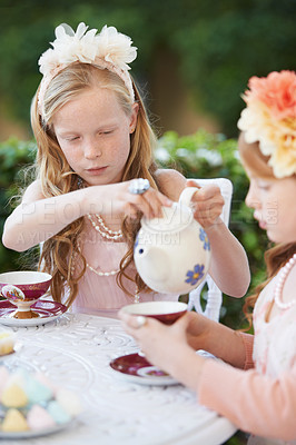 Buy stock photo Playing, tea and party with children in garden for pretend with sweets, flowers or kid fun. Princess, girl and fantasy with friends, teapot and cup in backyard with celebration, imagination and drink