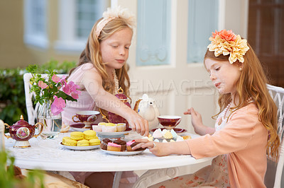 Buy stock photo Children, friends and tea in garden for party at birthday for snack for dress up game, fantasy or play. Female people, siblings and pot for hot drink in backyard for summer dessert, lunch or macarons
