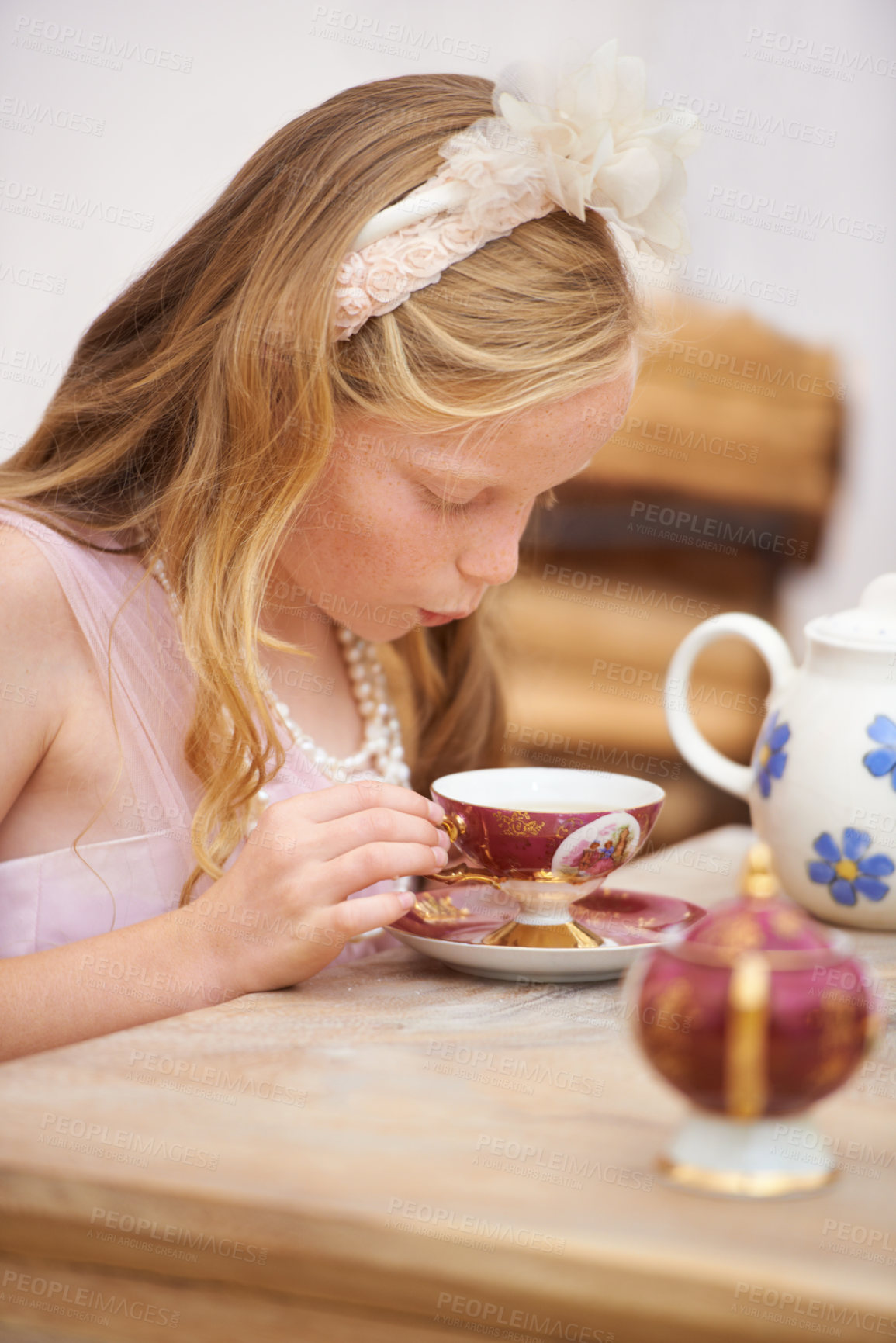 Buy stock photo Girl, child and tea party by table in garden for birthday, celebration and playing outdoor in home. Person, kid and porcelain cup in backyard of house with dress up, beverage and spring role play fun