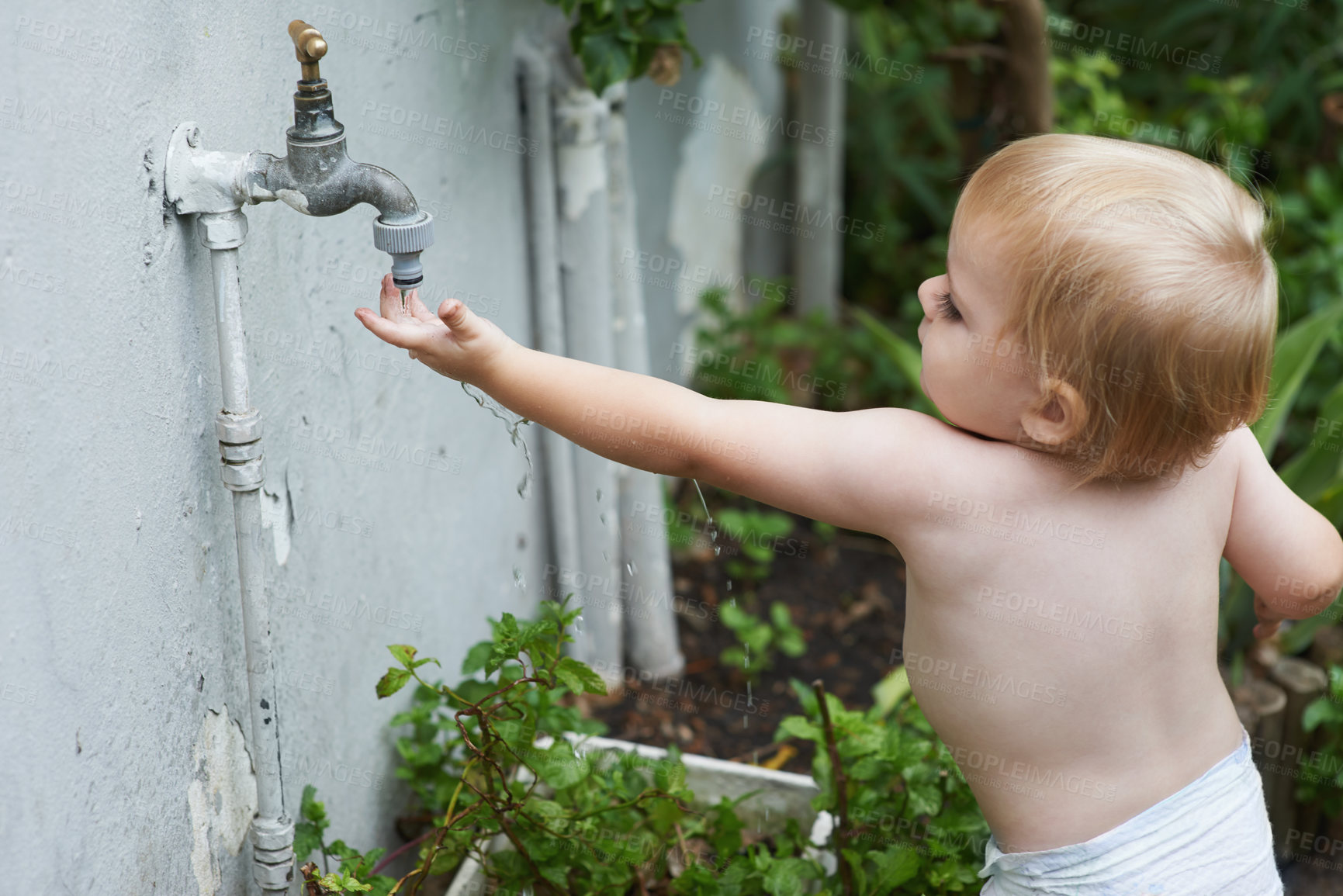 Buy stock photo Baby, playing with water and home in outdoor, development and growth for curiosity, backyard and diaper. Toddler, child and face in garden, alone and childhood memories for exploring with tap