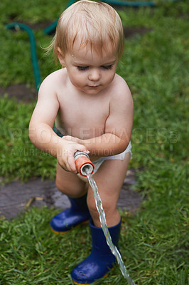 Buy stock photo Child, gardening and water grass with hose and learning to care for backyard and lawn. Kid, outdoor and play with hosepipe in summer, nature or environment and helping with sustainable growth at home
