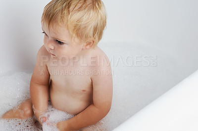 Buy stock photo Baby in bath, clean with bubbles and soap for morning routine with health, wellness and body care in home. Cute toddler washing in foam with hygiene, relax and calm child sitting in water in bathroom