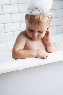 Buy stock photo Baby in bathtub, cleaning with bubbles and soap for morning routine with health, wellness and body care. Cute toddler washing in foam with hygiene, relax and calm child thinking in water in bathroom