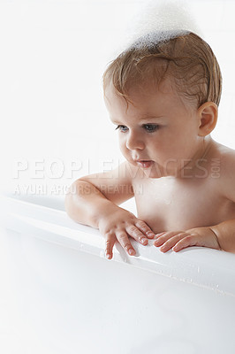 Buy stock photo An adorable baby boy standing in the bathtub
