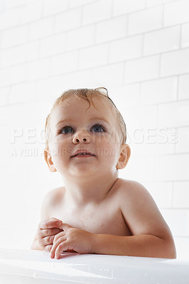 Buy stock photo Face of toddler in bath, clean skin with mockup in morning routine for health, wellness and body care in home. Cute baby washing in water with hygiene, relax and calm child sitting in tub in bathroom