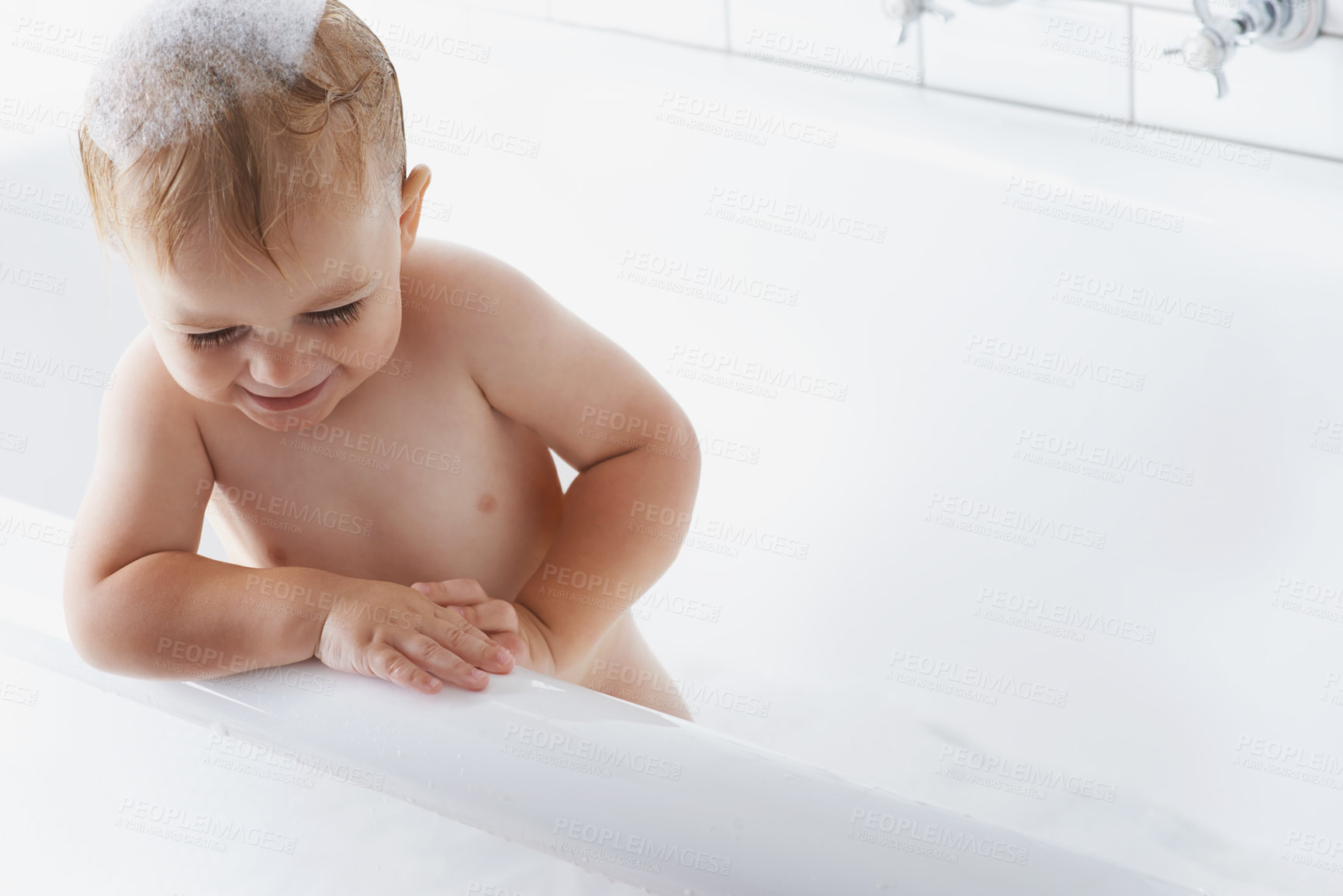 Buy stock photo Happy baby in bath with soap, bubbles and cleaning on mockup in morning routine for hygiene, wellness and care in home. Toddler washing in foam with smile, relax and laughing child in tub in bathroom