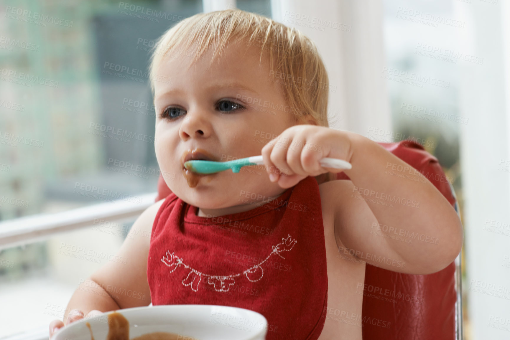 Buy stock photo Hungry, sweet and baby eating porridge for health, nutrition or child development at home. Food, cute and girl toddler or kid enjoying an organic puree meal for lunch or dinner in high chair at house