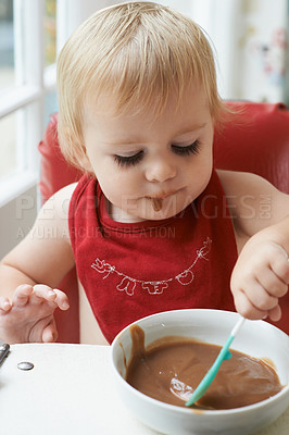 Buy stock photo High chair meal, spoon and baby eating in a house with diet, nutrition and child, wellness or development. Food, messy eater and boy kid curious about breakfast porridge, playing or learning at home