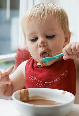 Buy stock photo A baby feeding herself