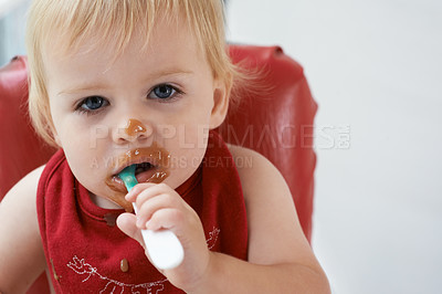 Buy stock photo Hungry, portrait and baby eating porridge for health, nutrition or child development at home. Food, cute and girl toddler or kid enjoying organic puree meal for lunch or dinner in high chair at house