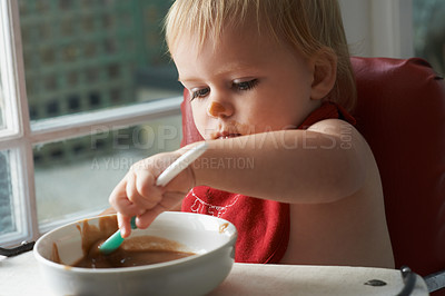 Buy stock photo High chair meal, spoon and baby eating in a house with diet, nutrition and child development wellness. Food, messy eater and little boy kid curious about breakfast, playing or learning in his home