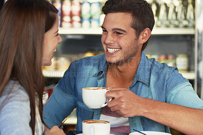 Buy stock photo Love, happy and couple drinking coffee in cafe, care and bonding together on valentines day date. Funny man, woman in restaurant and latte for conversation, laughing at joke and relationship in shop