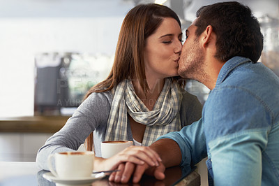Buy stock photo Love, kiss and couple in coffee shop, cafe and bonding together on valentines day date. Romance, man and woman in restaurant with latte drink, connection and care in healthy relationship commitment
