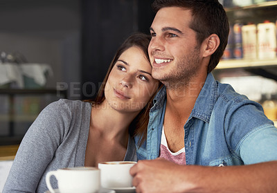 Buy stock photo Love, happy and couple drinking coffee in cafe, care and bonding together on valentines day date. Romance, man and woman in restaurant with latte for connection, commitment and relationship in shop