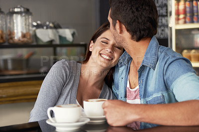 Buy stock photo Shot of a young couple talking together in a cafe