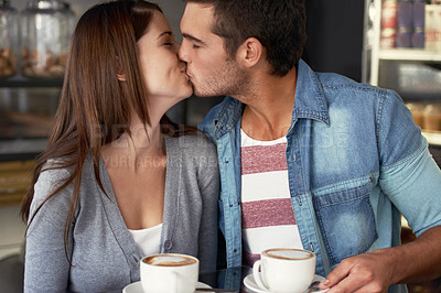 Buy stock photo Love, kiss and couple drinking coffee in cafe, care and bonding together on valentines day date. Romance, man and woman in restaurant with latte for connection, commitment and relationship in shop