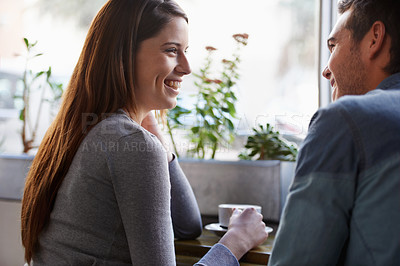 Buy stock photo Shot of a young couple talking together in a cafe